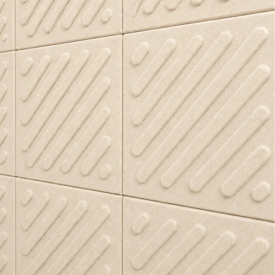 Close-up of cream acoustic felt wall panels highlighting the fibrous texture, raised relief and module connections