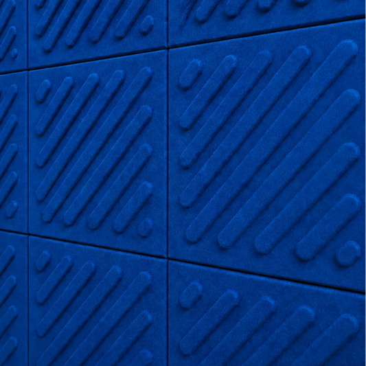 Close-up of indigo acoustic felt wall panels highlighting the fibrous texture, raised relief and module connections