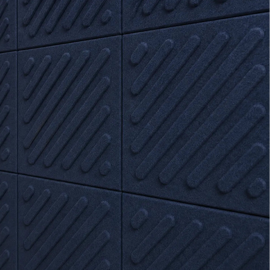 Close-up of navy acoustic felt wall panels highlighting the fibrous texture, raised relief and module connections