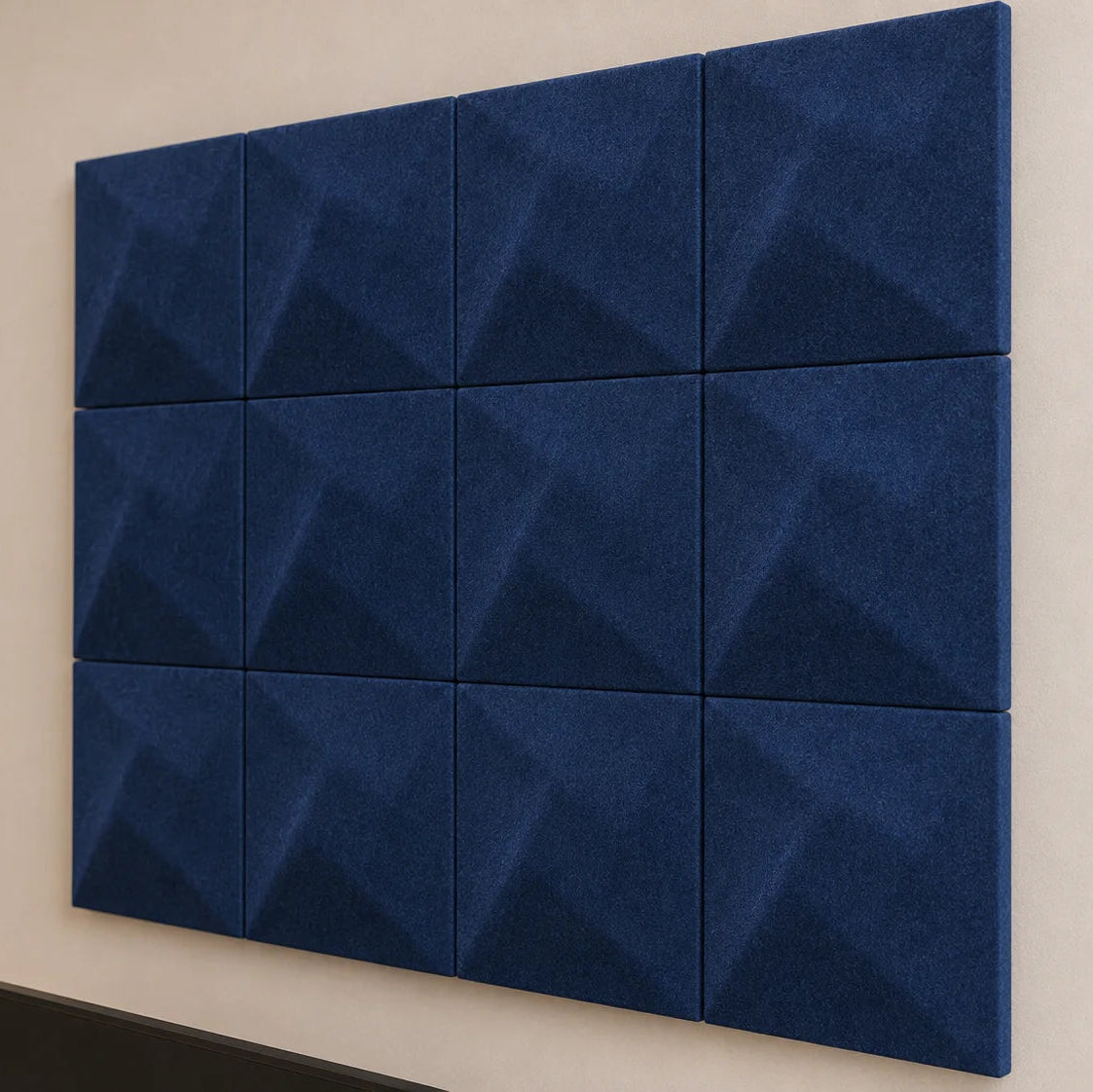 Close-up of navy square felt acoustic panels showing subtle Twist relief, even joints and textured fibres