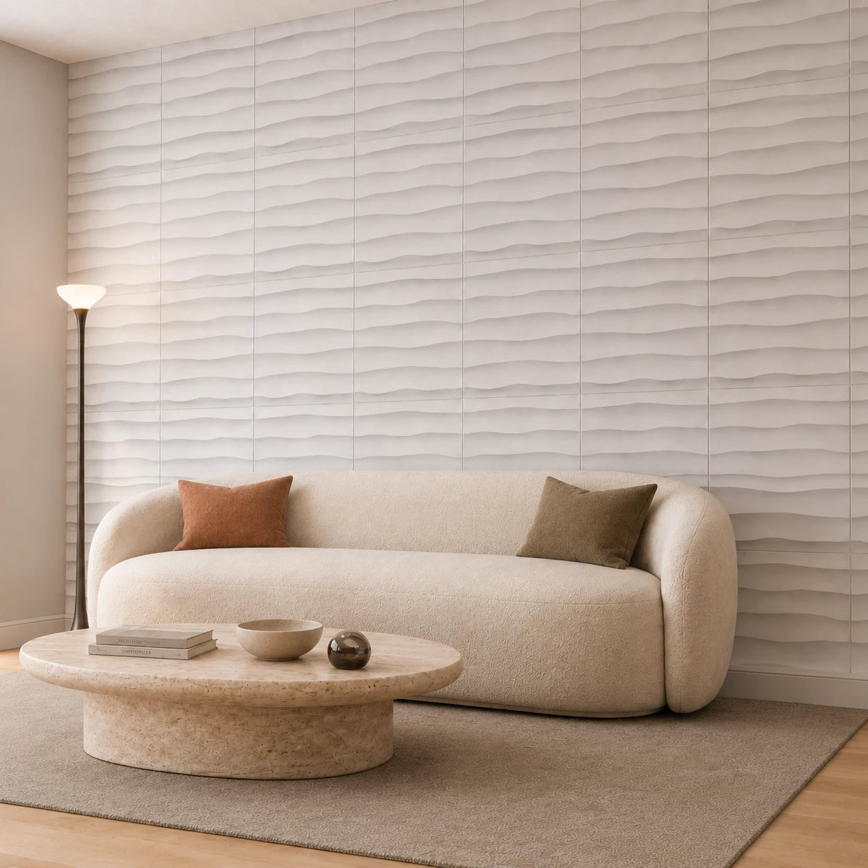 Angled view of an elegant beige living room with a curved sofa, stone coffee table, and white wave-patterned 3D wall panels