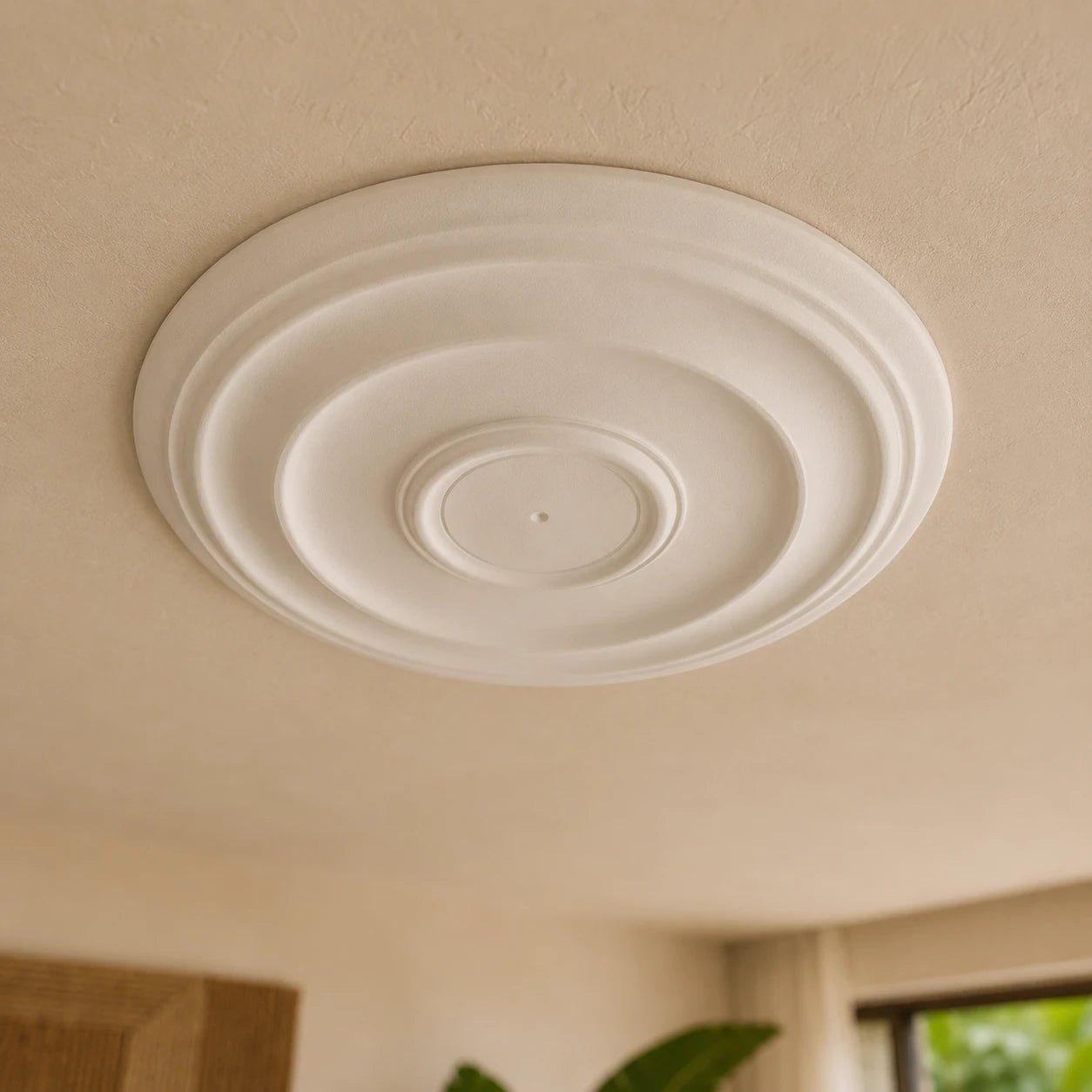 Close-up of the white Andrina ceiling rose with smooth stepped circular reliefs and a small central mounting point
