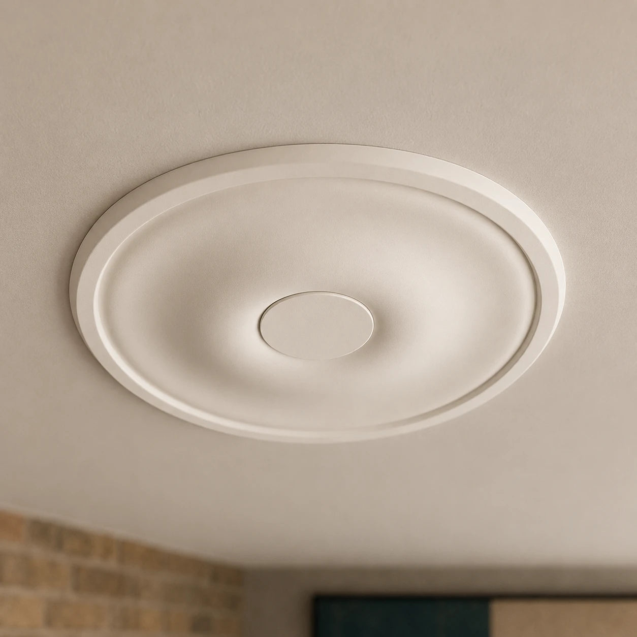 Close-up of the minimalist white Ava ceiling rose with a broad flat surface, raised outer rim and small central disc