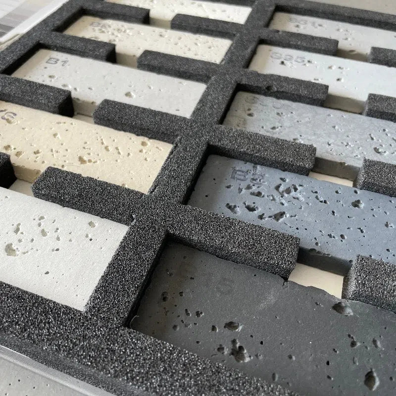 Concrete wall panel sample book in a box closeup photo DecorMania.eu