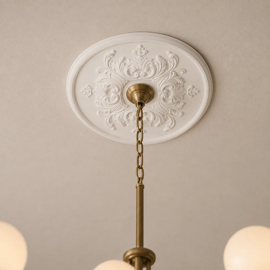 Close-up of the white Sara R1520 ceiling rose with symmetrical scrollwork and a centrally mounted brass chandelier.